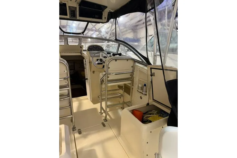 Slide: The Image of Interior view of a 2005 Scout 280 Abaco boat, featuring helm and seating area. - 4
