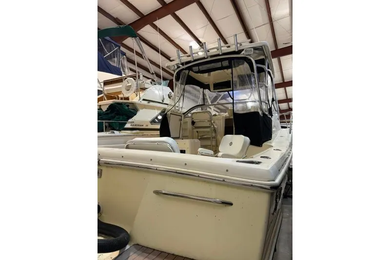 Slide: The Image of 2005 Scout 280 Abaco boat in indoor storage, showcasing rear view and seating area. - 5