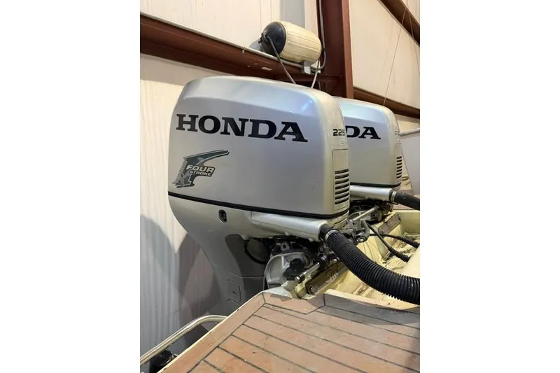 Slide: The Image of Twin Honda outboard engines on a 2005 Scout 280 Abaco boat in a storage facility. - 7