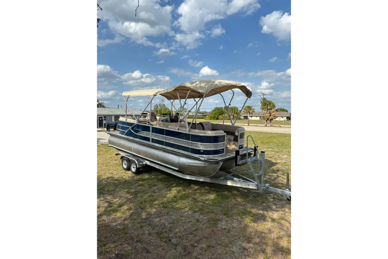 Slide: The Image of 2026 Bentley Pontoons Legacy 223 Navigator on trailer, blue sky. - 10