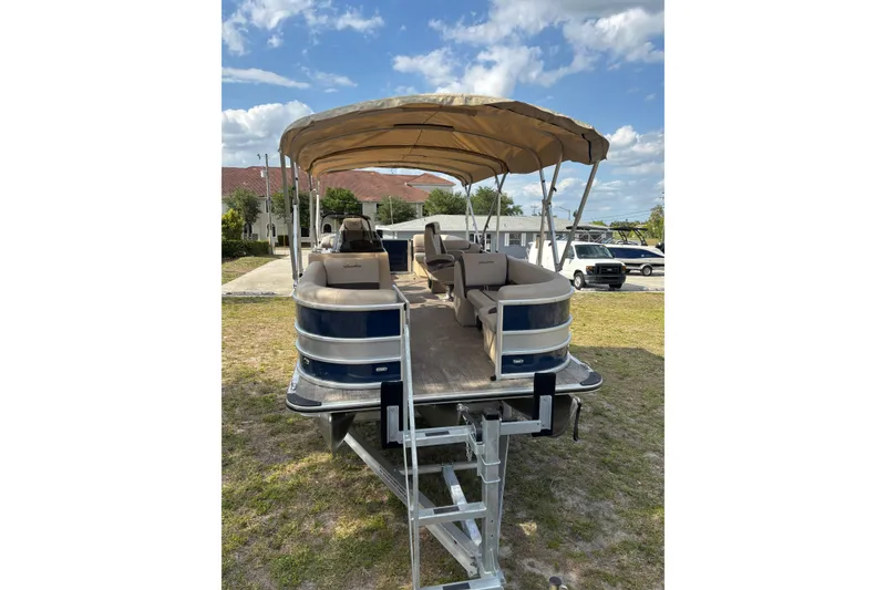 Slide: The Image of 2026 Bentley Pontoons Legacy 223 Navigator on trailer, blue sky. - 11