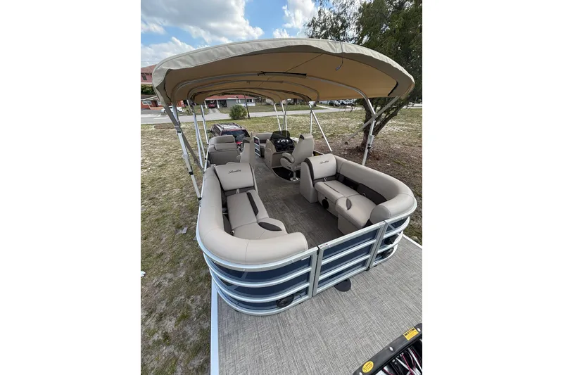 Slide: The Image of 2026 Bentley Pontoons Legacy 223 Navigator with canopy and seating area. - 12