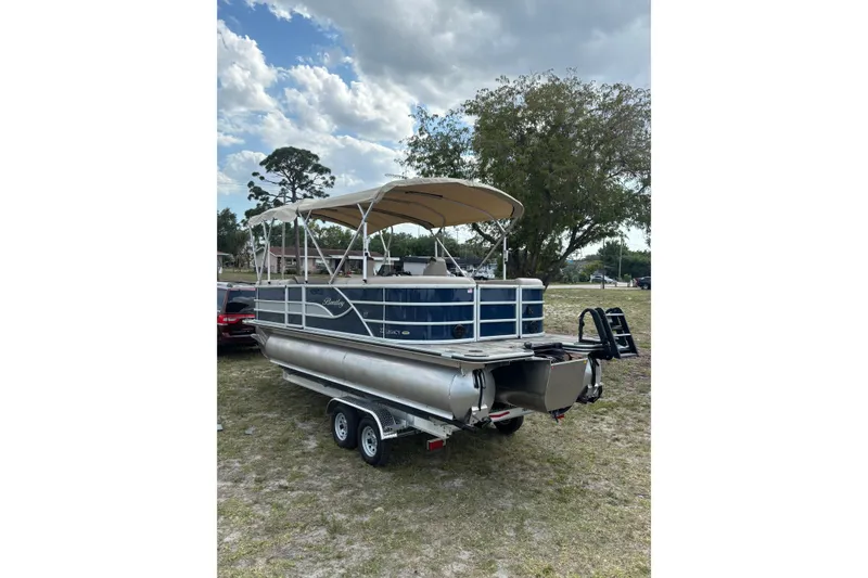 Slide: The Image of 2026 Bentley Pontoons Legacy 223 Navigator on trailer, parked outdoors. - 5
