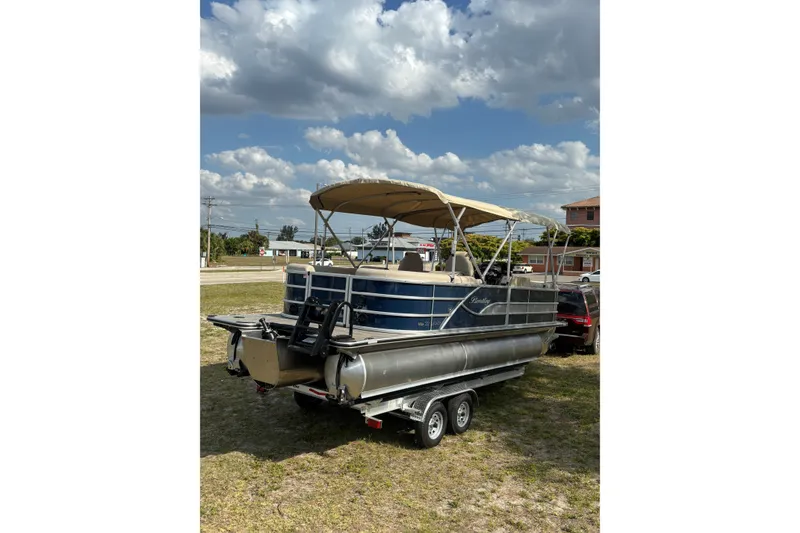 Slide: The Image of 2026 Bentley Pontoons Legacy 223 Navigator on trailer under cloudy sky. - 7