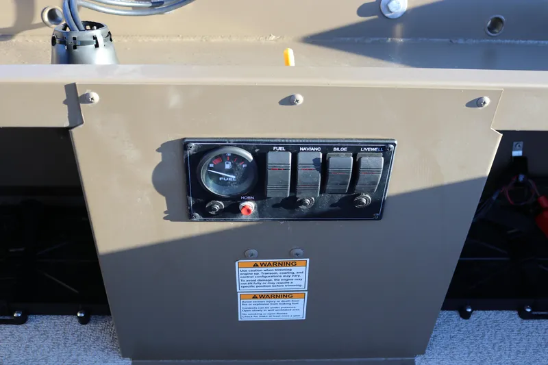 Slide: The Image of Control panel of 2026 Smoker Craft Pro Sportsman 1866 boat with fuel gauge and switches. - 11