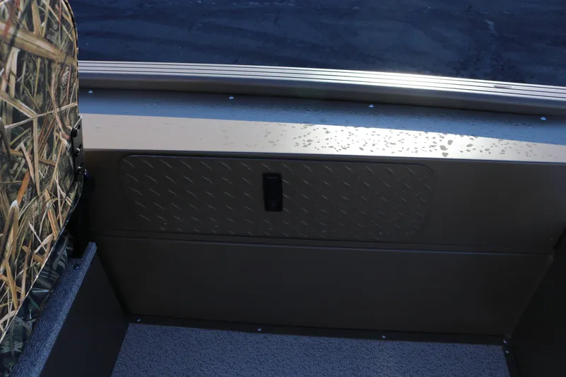 Slide: The Image of 2026 Smoker Craft Pro Sportsman 1866 interior with camo seat and metal paneling. - 14