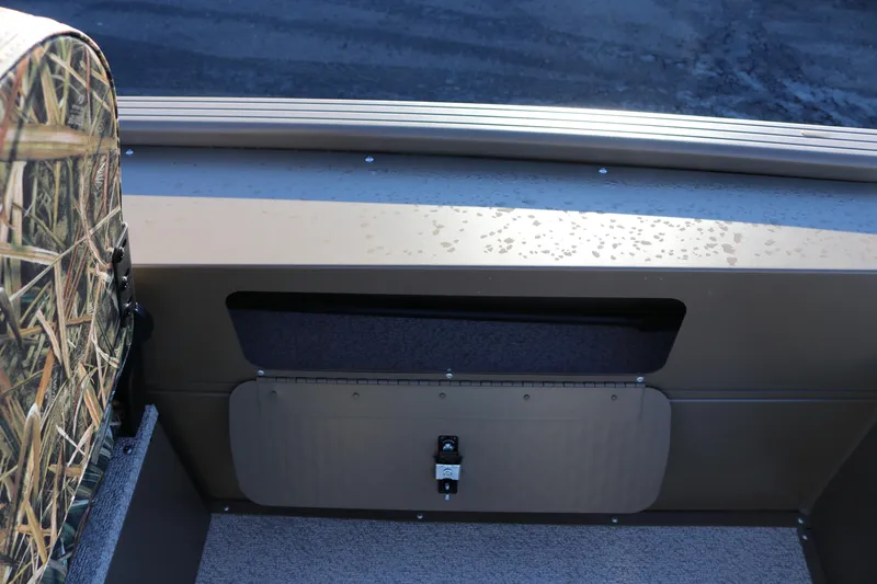 Slide: The Image of Interior view of 2026 Smoker Craft Pro Sportsman 1866 boat with camo seat and storage compartment. - 15