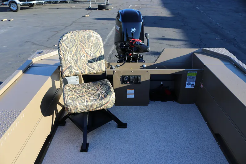 Slide: The Image of 2026 Smoker Craft Pro Sportsman 1866 boat interior with camo seat and motor. - 17