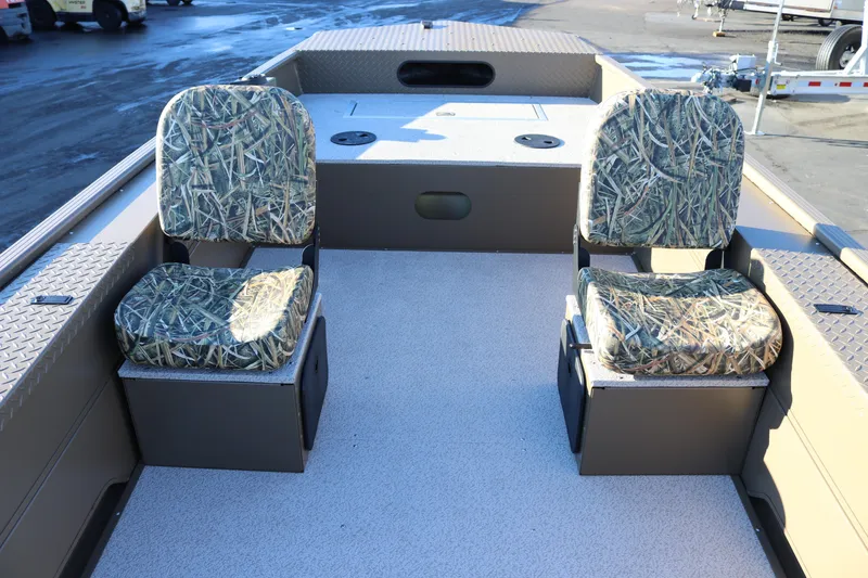 Slide: The Image of 2026 Smoker Craft Pro Sportsman 1866 boat interior with camo seats and storage compartments. - 18