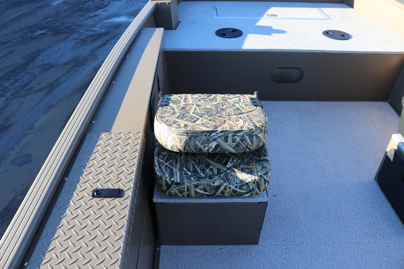 Slide: The Image of 2026 Smoker Craft Pro Sportsman 1866 boat interior with camo seats and storage. - 4