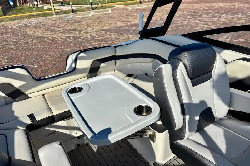 Slide: The Image of Interior of 2016 Yamaha Boats AR240 HO with seating and table setup. - 16