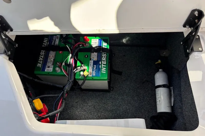 Slide: The Image of 2016 Yamaha AR240 HO boat battery compartment with Interstate deep cycle batteries and fire extinguisher. - 21