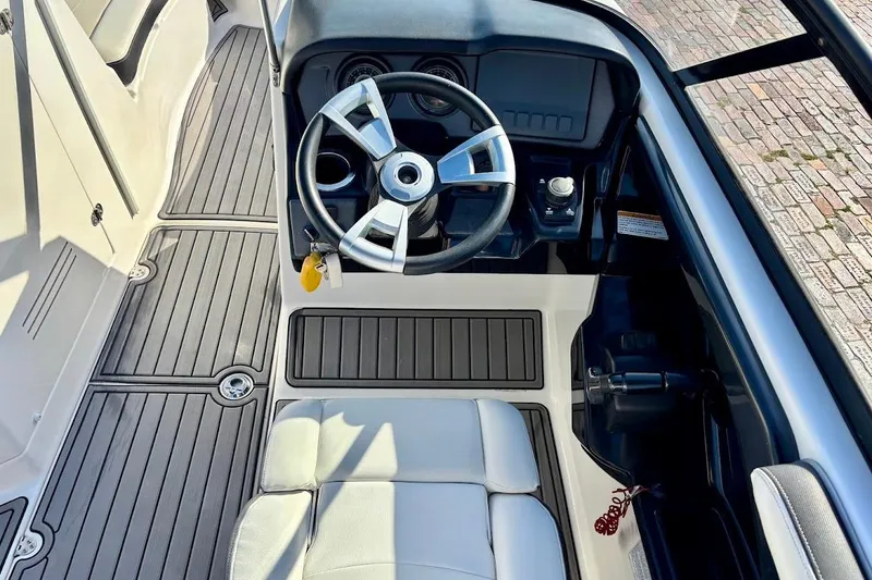 Slide: The Image of 2016 Yamaha AR240 HO boat cockpit with steering wheel and controls. - 22