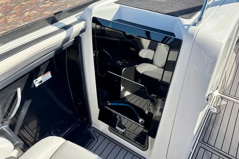 Slide: The Image of 2016 Yamaha Boats AR240 HO interior with seating and storage area. - 24