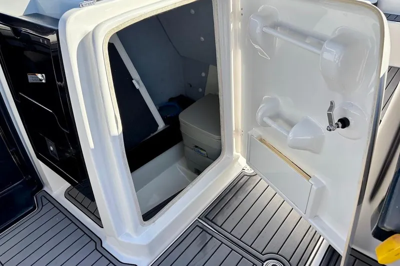 Slide: The Image of 2016 Yamaha Boats AR240 HO interior storage compartment with open door. - 26