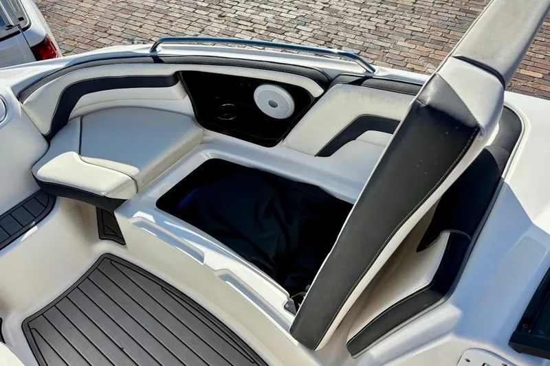 Slide: The Image of 2016 Yamaha Boats AR240 HO interior seating with storage compartment open. - 28
