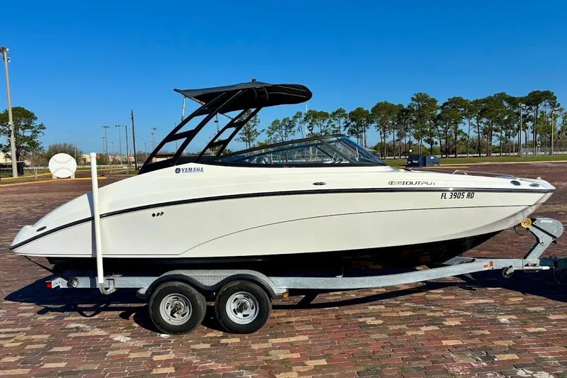 Slide: The Image of 2016 Yamaha Boats AR240 HO on trailer, parked outdoors under clear blue sky. - 6