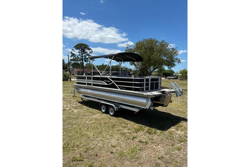 Slide: The Image of 2026 Bentley Pontoons Fish 243 4-Point on trailer outdoors. - 21