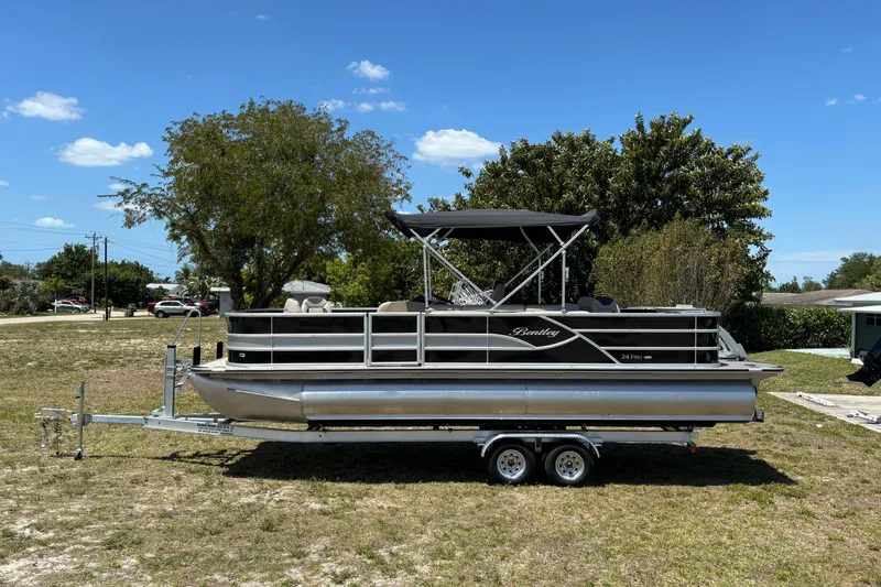 Slide: The Image of 2026 Bentley Pontoons Fish 243 4-Point on trailer outdoors. - 24