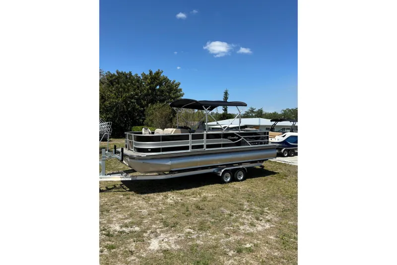 Slide: The Image of 2026 Bentley Pontoons Fish 243 4-Point on trailer outdoors. - 26
