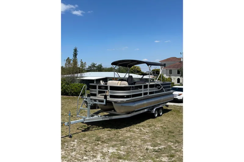 Slide: The Image of 2026 Bentley Pontoons Fish 243 4-Point on trailer outdoors. - 27