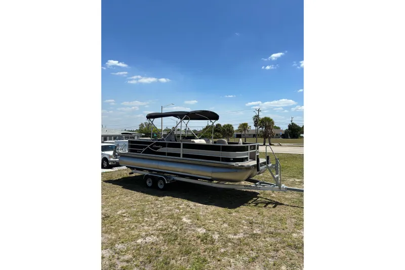 Slide: The Image of 2026 Bentley Pontoons Fish 243 4-Point on trailer under sunny skies. - 4