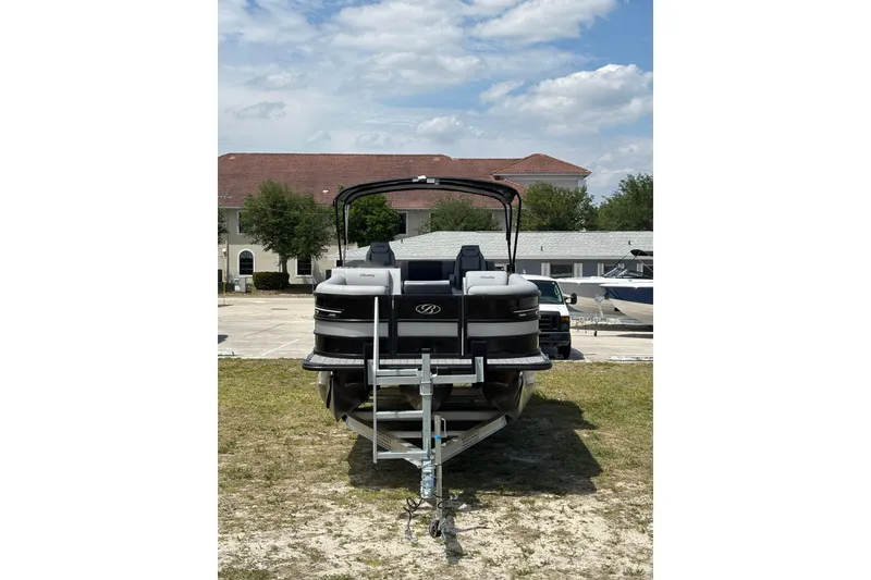 Slide: The Image of 2026 Bentley Pontoons Elite 253 Swingback on trailer, parked outdoors. - 15