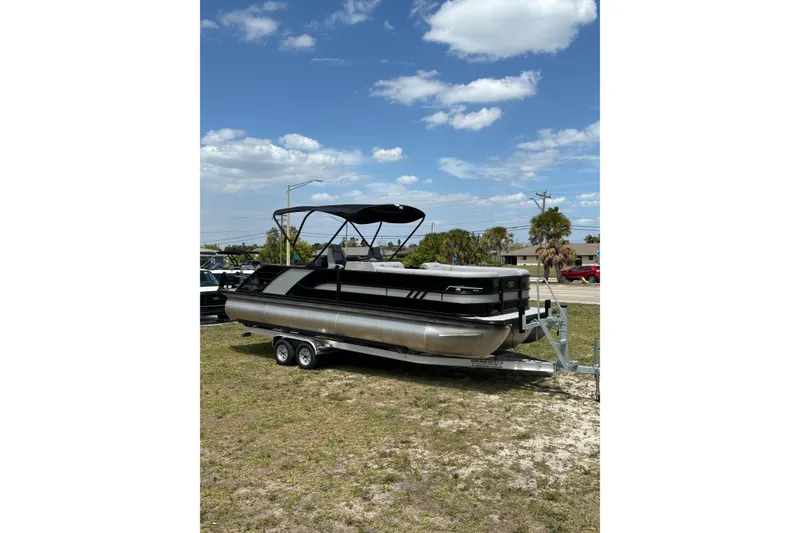 Slide: The Image of 2026 Bentley Pontoons Elite 253 Swingback on trailer, blue sky. - 16