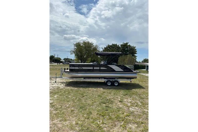 Slide: The Image of 2026 Bentley Pontoons Elite 253 Swingback on trailer outdoors. - 17