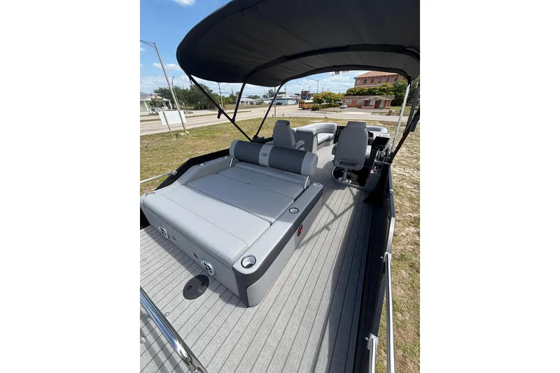 Slide: The Image of 2026 Bentley Pontoons Elite 253 Swingback with gray interior and sunshade. - 21