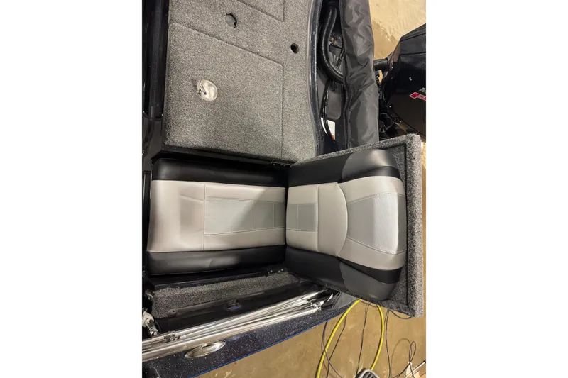 Slide: The Image of 2026 Nitro ZV19 Sport Pro boat seat and storage compartment, featuring gray and black upholstery. - 10