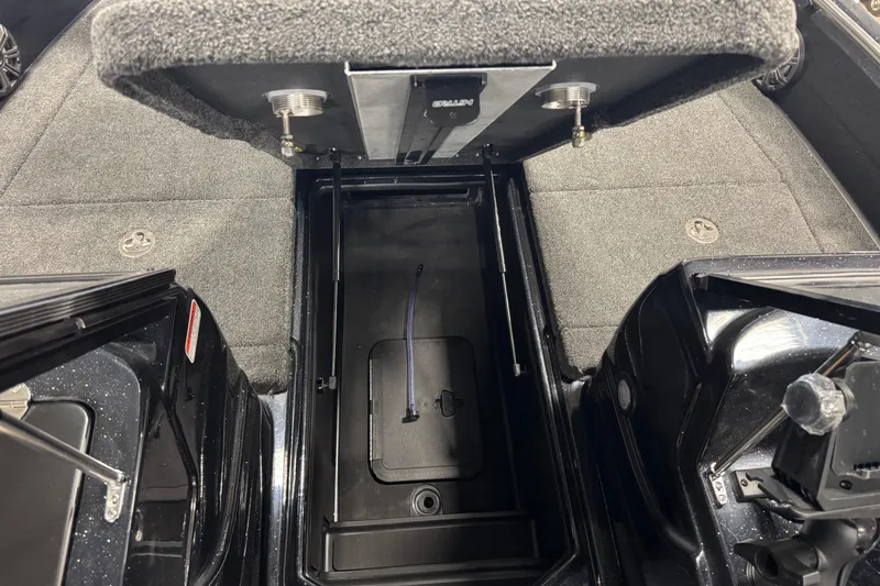 Slide: The Image of Interior storage compartment of 2026 Nitro ZV19 Sport Pro boat, featuring carpeted flooring. - 12