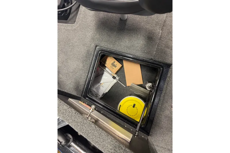 Slide: The Image of Storage compartment in 2026 Nitro ZV19 Sport Pro boat, containing various items. - 15