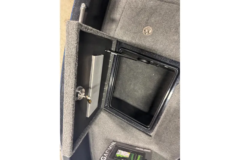 Slide: The Image of Interior storage compartment of 2026 Nitro ZV19 Sport Pro boat, featuring secure lock and Garmin device. - 16