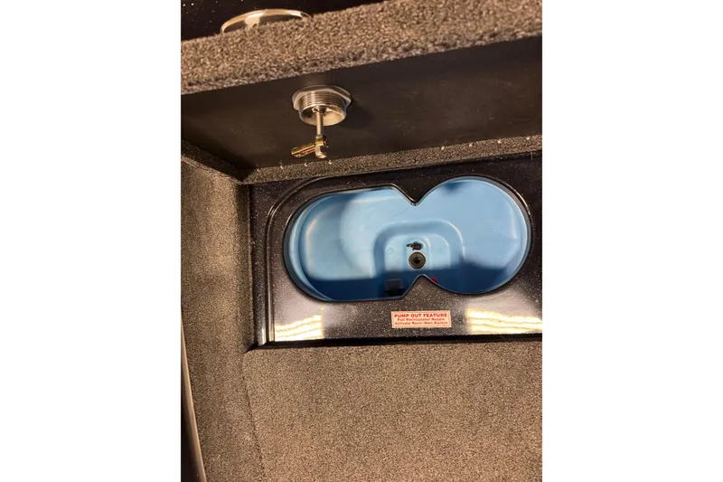 Slide: The Image of 2026 Nitro ZV19 Sport Pro boat compartment with key lock and pump-out feature. - 17