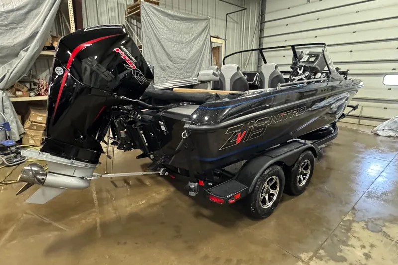 Slide: The Image of 2026 Nitro ZV19 Sport Pro boat in a garage, featuring a powerful outboard motor. - 2