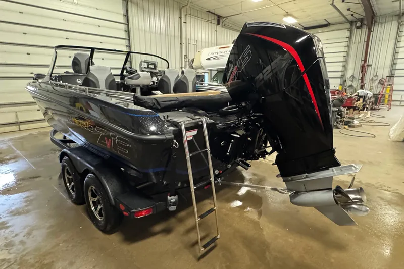 Slide: The Image of 2026 Nitro ZV19 Sport Pro boat in a garage, featuring a powerful outboard motor. - 3