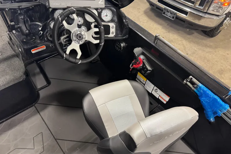 Slide: The Image of Interior of 2026 Nitro ZV19 Sport Pro boat with steering wheel and seat. - 5
