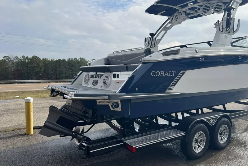 Slide: The Image of 2022 Cobalt R8 Surf boat on trailer, featuring sleek design and advanced surf technology. - 13