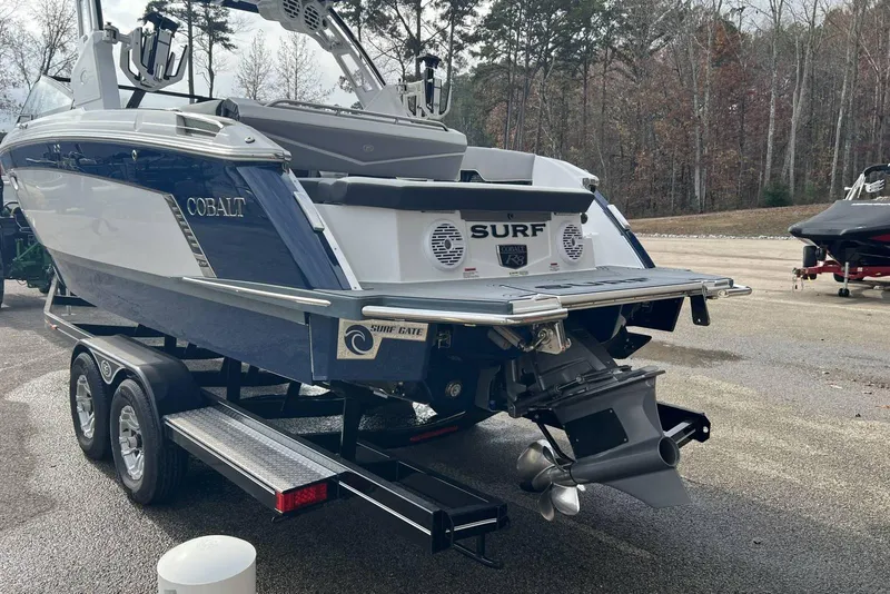 Slide: The Image of 2022 Cobalt R8 Surf boat on trailer, rear view, in outdoor setting. - 14