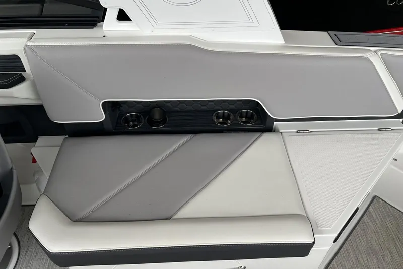 Slide: The Image of 2022 Cobalt R8 Surf boat interior with gray seating and cup holders. - 20