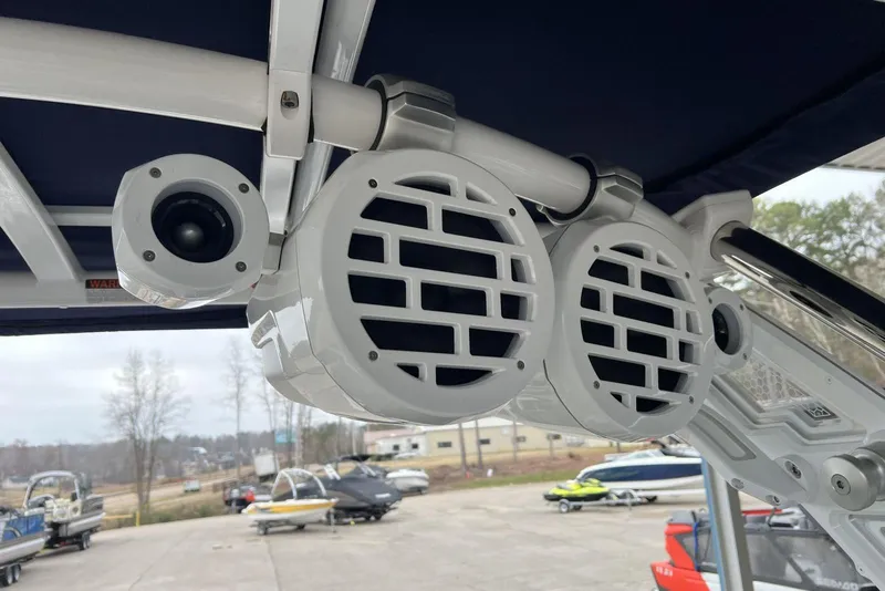 Slide: The Image of 2022 Cobalt R8 Surf boat speakers and camera on deck, marina background. - 21