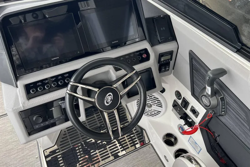 Slide: The Image of 2022 Cobalt R8 Surf boat dashboard with steering wheel and Garmin displays. - 23