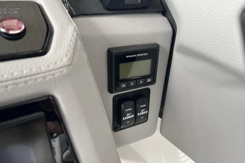 Slide: The Image of Control panel of a 2022 Cobalt R8 Surf boat featuring Volvo Penta and Lenco switches. - 26