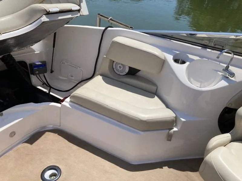Slide: The Image of Interior of a 2009 Regal 2450 Cuddy boat with seating area. - 12