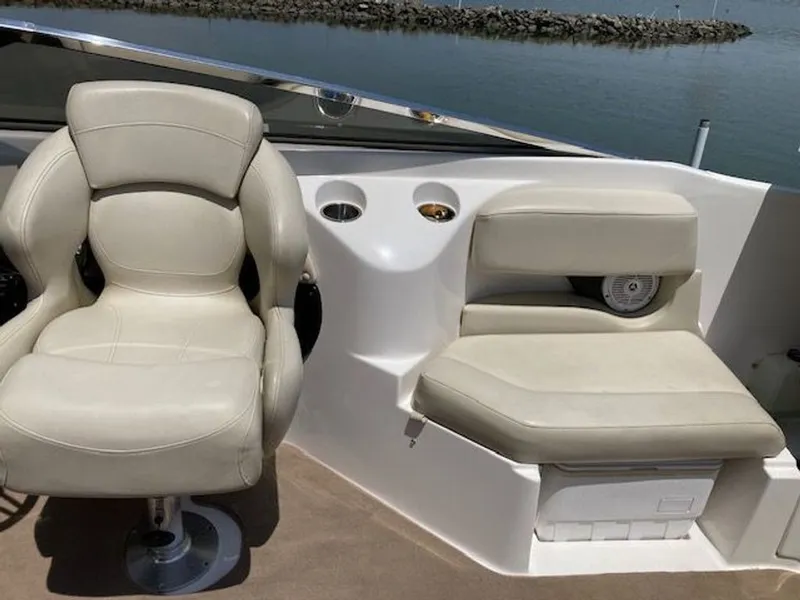 Slide: The Image of Interior of a 2009 Regal 2450 Cuddy boat with beige seats. - 13