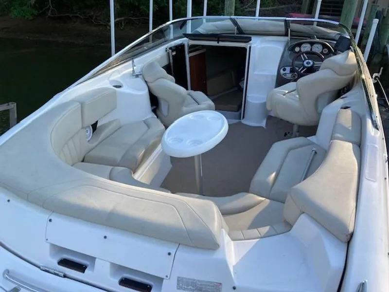 Slide: The Image of Interior of a 2009 Regal 2450 Cuddy boat with seating area. - 15