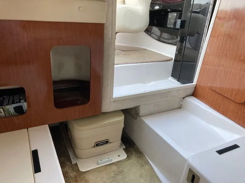 Slide: The Image of Interior of a 2009 Regal 2450 Cuddy boat with seating area. - 18