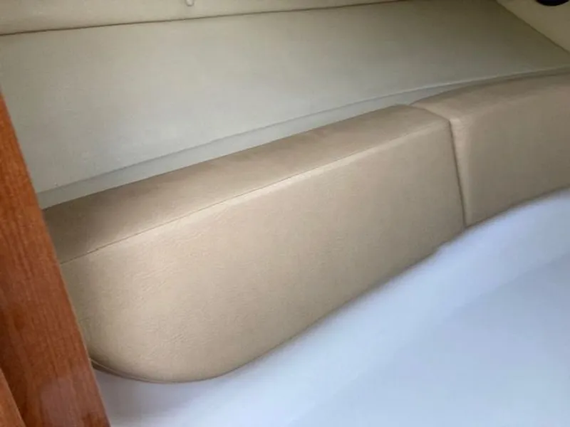 Slide: The Image of Interior of 2009 Regal 2450 Cuddy with beige upholstery. - 26