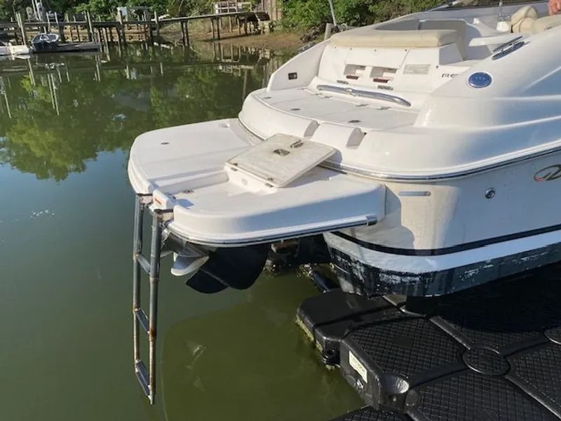 Slide: The Image of 2009 Regal 2450 Cuddy boat at dock with swim platform. - 32